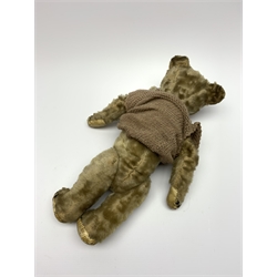 Early 20th century plush covered straw filled teddy bear, the revolving head with boot button eyes and traces of stitched nose and mouth on body with jointed limbs H42cm