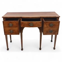 George III Sheraton-style mahogany sideboard, serpentine front fitted with central drawer and flanked by two deep drawers, raised on square tapered legs with spade feet 