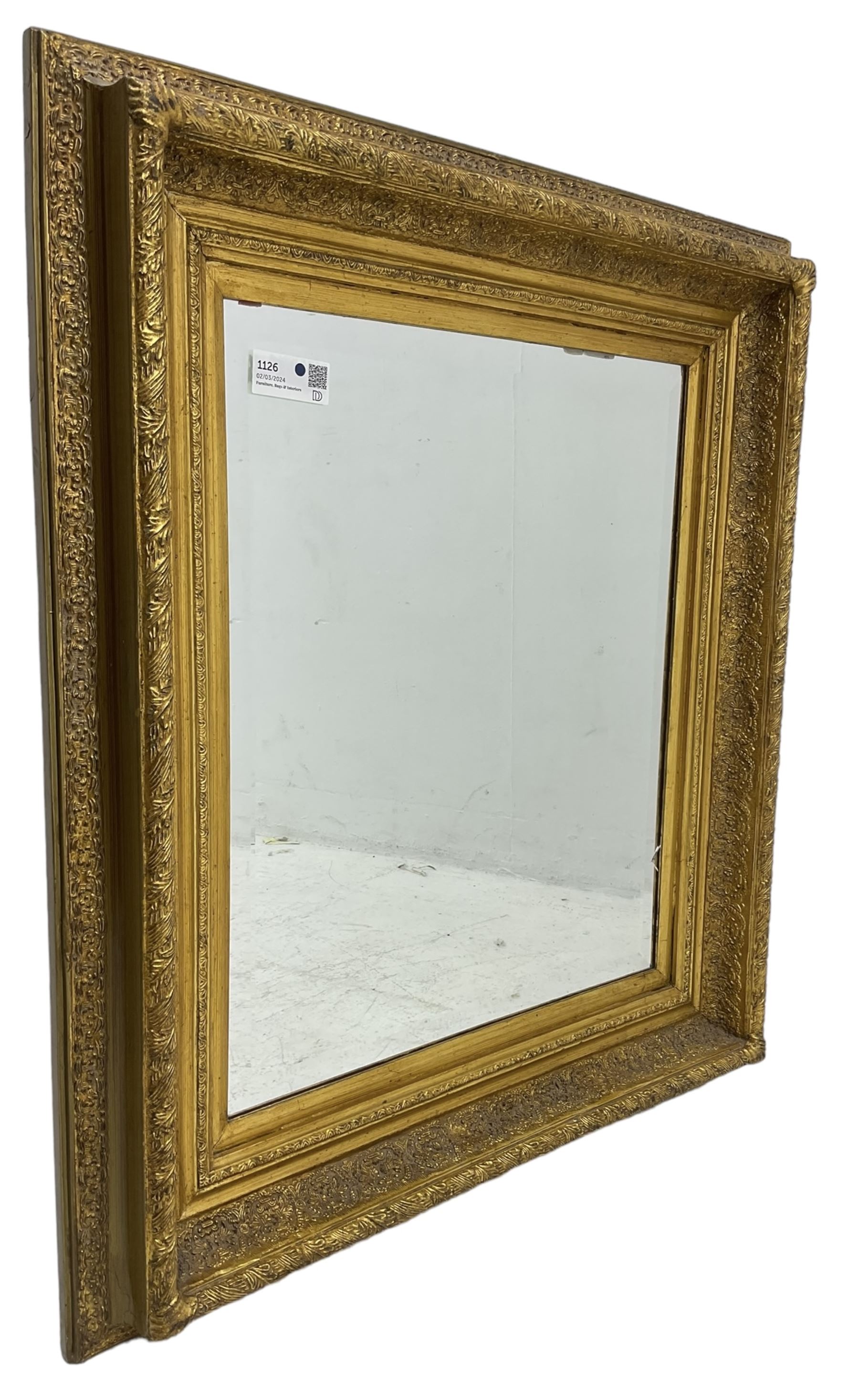 Victorian design gilt wall mirror, the frame decorated with moulded gold foliate patterns, with rectangular bevelled plate