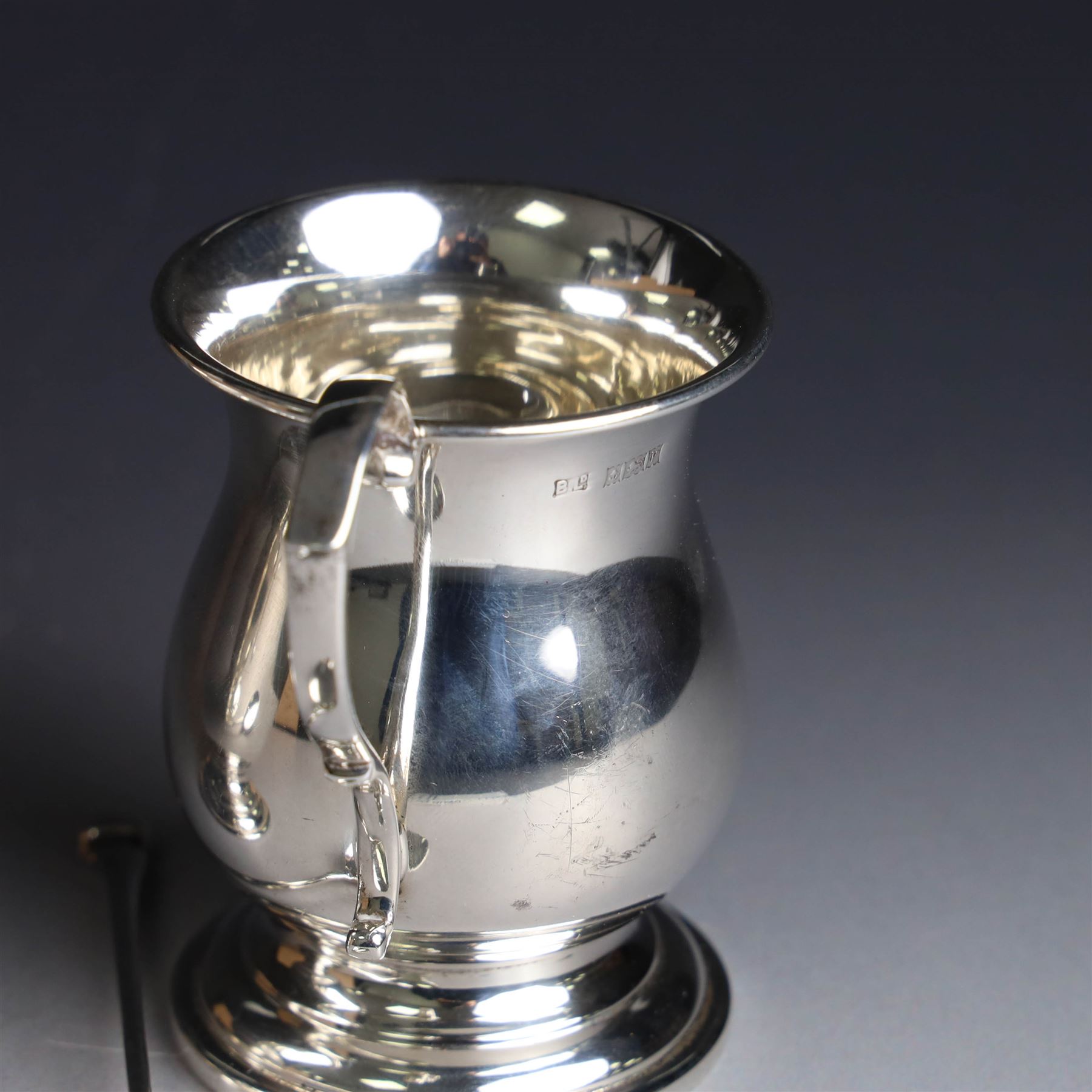 Two late 20th century silver christening mugs, each of plain form with no engraving, together with a small seal top spoon, all hallmarked 