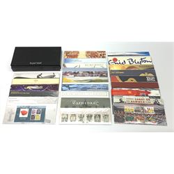 Queen Elizabeth II Presentation packs, face value of usable postage stamps approximately 70 GBP, housed in a Royal Mail black card storage box