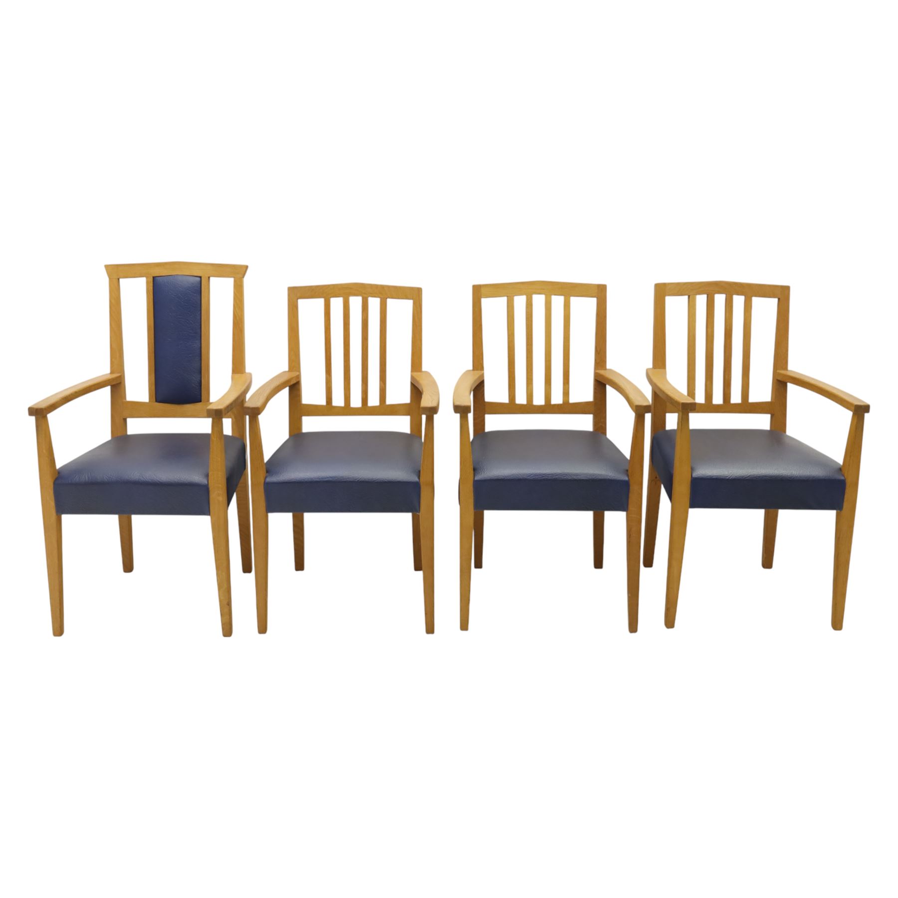 Modern twelve oak dining chairs including one 'Chairmans' chair, solid oak construction, slatted back and arm rests, blue leatherette padded seat, on tapered square supports 