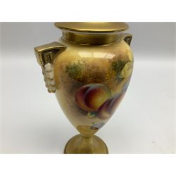 Pair of mid/late 20th century Royal Worcester vases and covers decorated by Frank Roberts, each of slender ovoid form with twin key and husk handles, and gilt covers, hand painted with a still life of fruit upon a mossy ground, signed F Roberts, upon a gilt circular pedestal foot, with black printed marks beneath including shape number 2713, H20.5cm