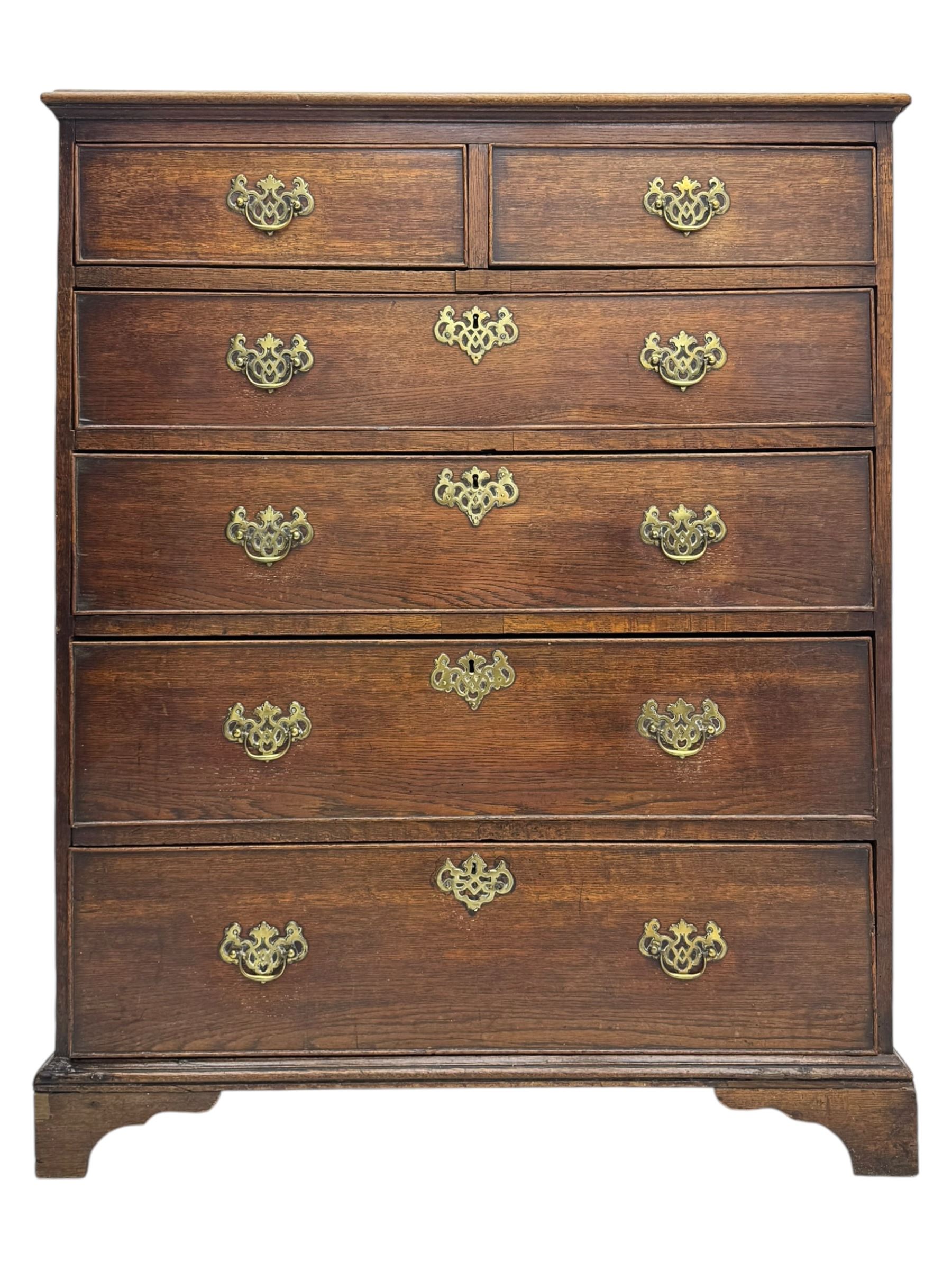 George III oak chest of drawers fitted with two short over four long drawers fitted with swan neck handles, supported on bracket feet