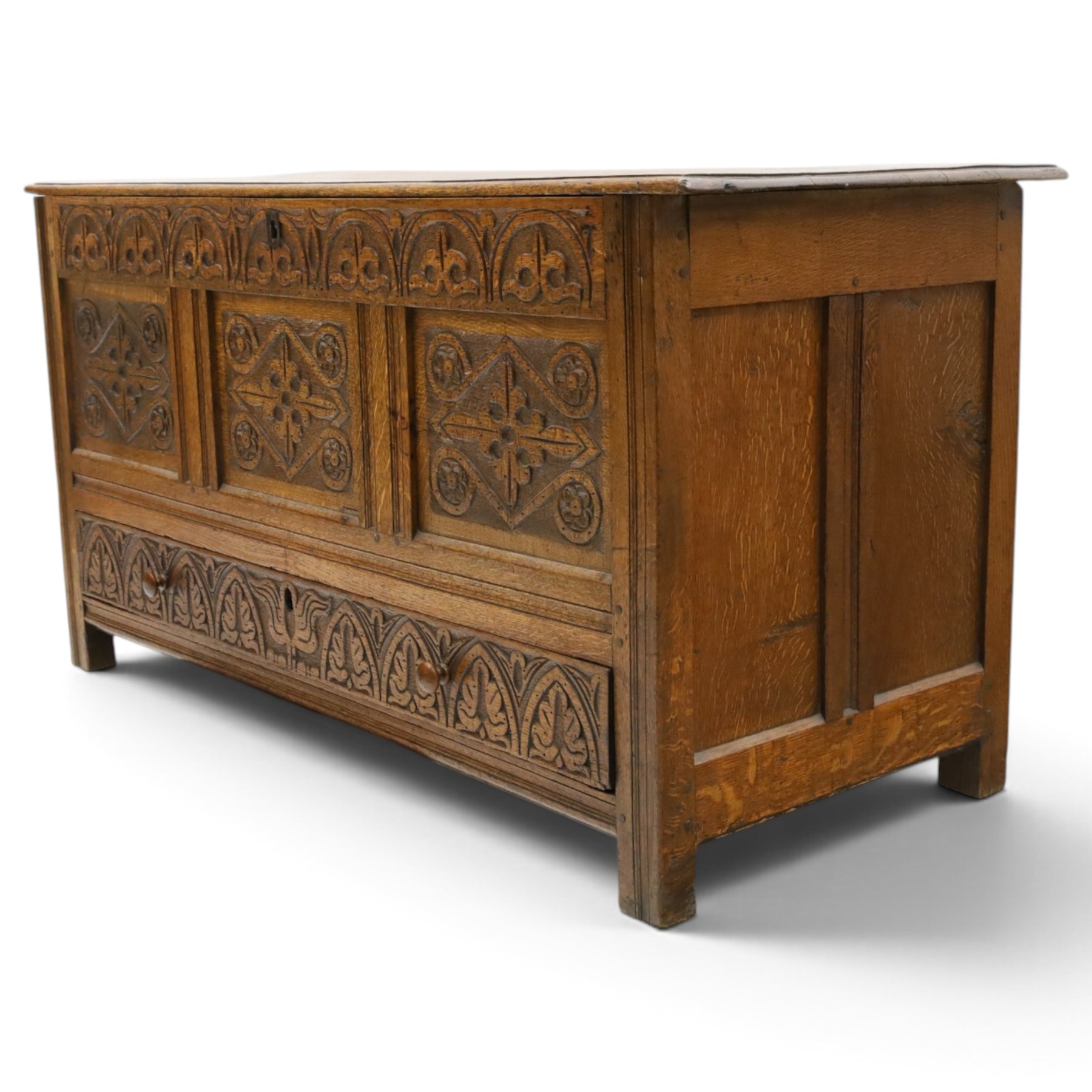 18th century carved oak coffer, rectangular hinged top over a lunette-carved frieze and tracery-style carved triple panelled front, the lower rail carved with repeating anthemion motifs, on square feet