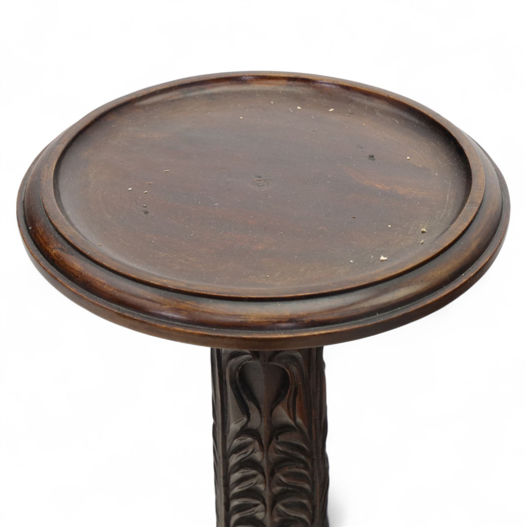 Late 20th century carved mahogany torchère stand, dished top above heavily carved column, with turned elements on moulded square base upon bun feet