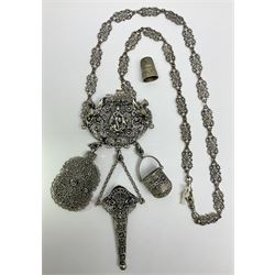 19th century continental silver plated chatelaine, the main body flanked with winged mythical beasts and central soldier slaying a dragon supporting three suspended items to include velvet lined small basket and long clasped filigree chain, together with a thimble