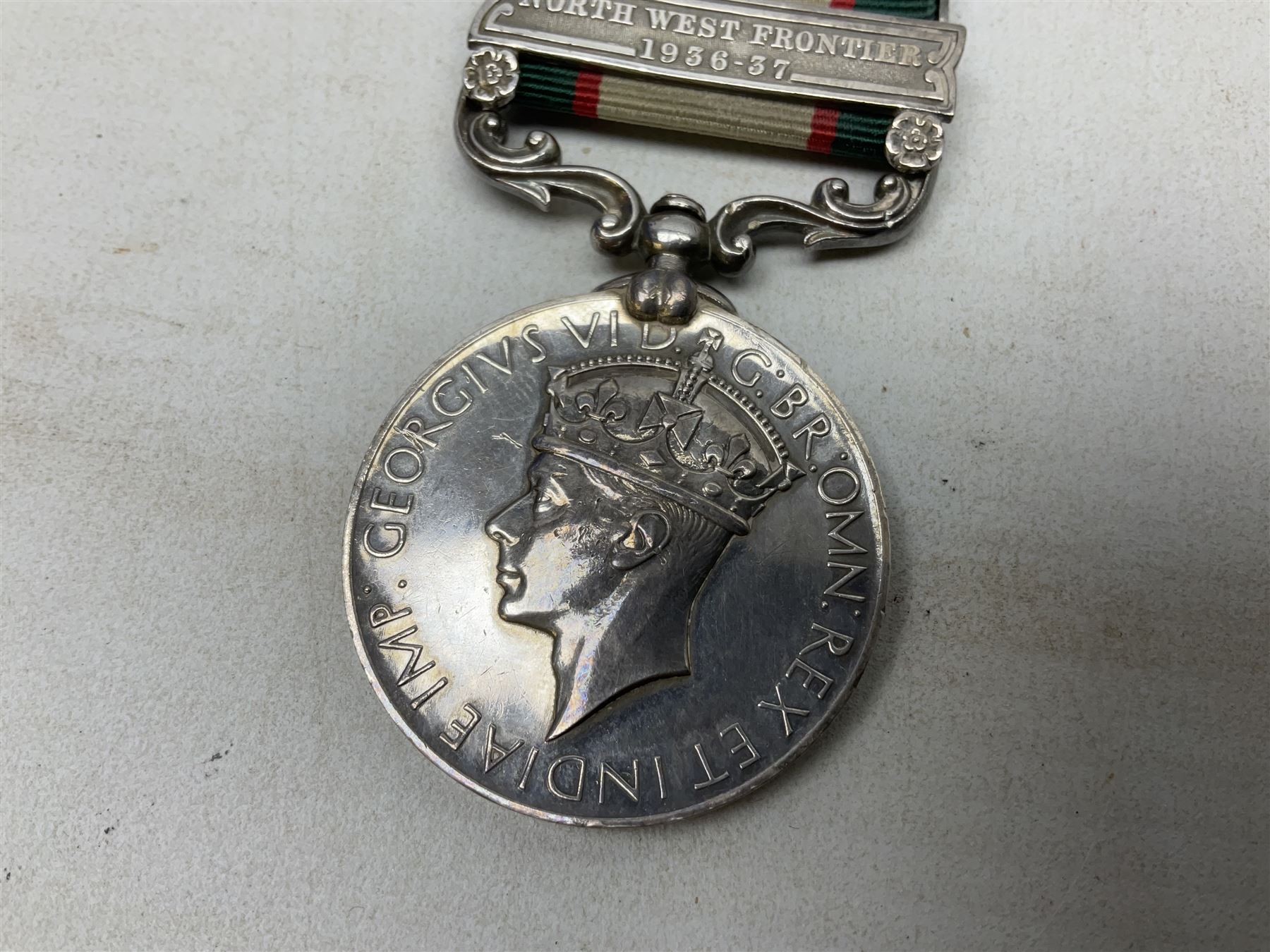 George VI India General Service Medal with North West Frontier 1936-37 clasp awarded to Bearer Khan Akbar 2-Border R.; with ribbon
