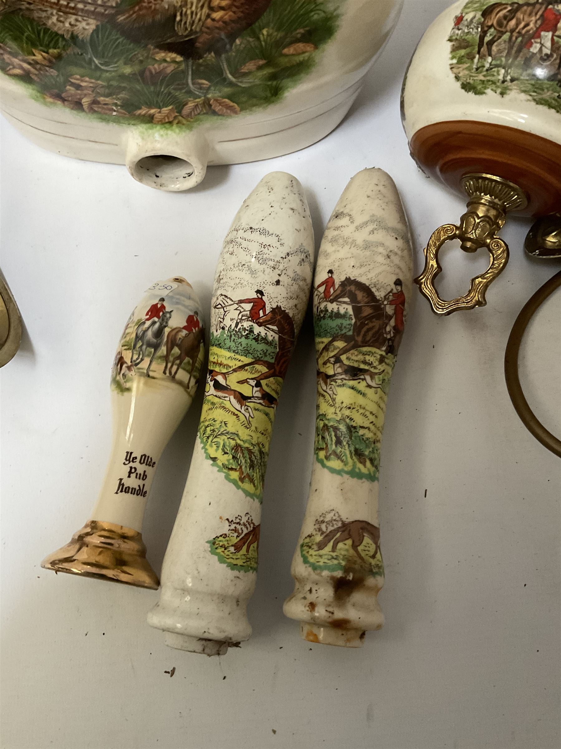 Ceramic hanging light fittings decorated with fox hunting scenes with brass fixtures, ceramic beer pulls decorated with hunting scenes and ceramic whisky barrel decorated with a pheasant