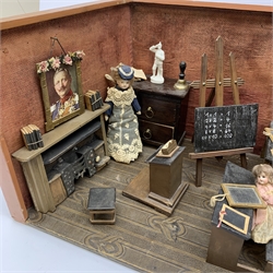 Late Victorian wooden school room setting with bisque head teacher and six German all bisque pupils each seated at a combined desk and chair with slate board, in a classroom furnished with chest of drawers, fire-surround, lectern, wall map, pictures, miniature books, school bell, chalk board on easel, wall clock etc, L70cm H28cm D28cm