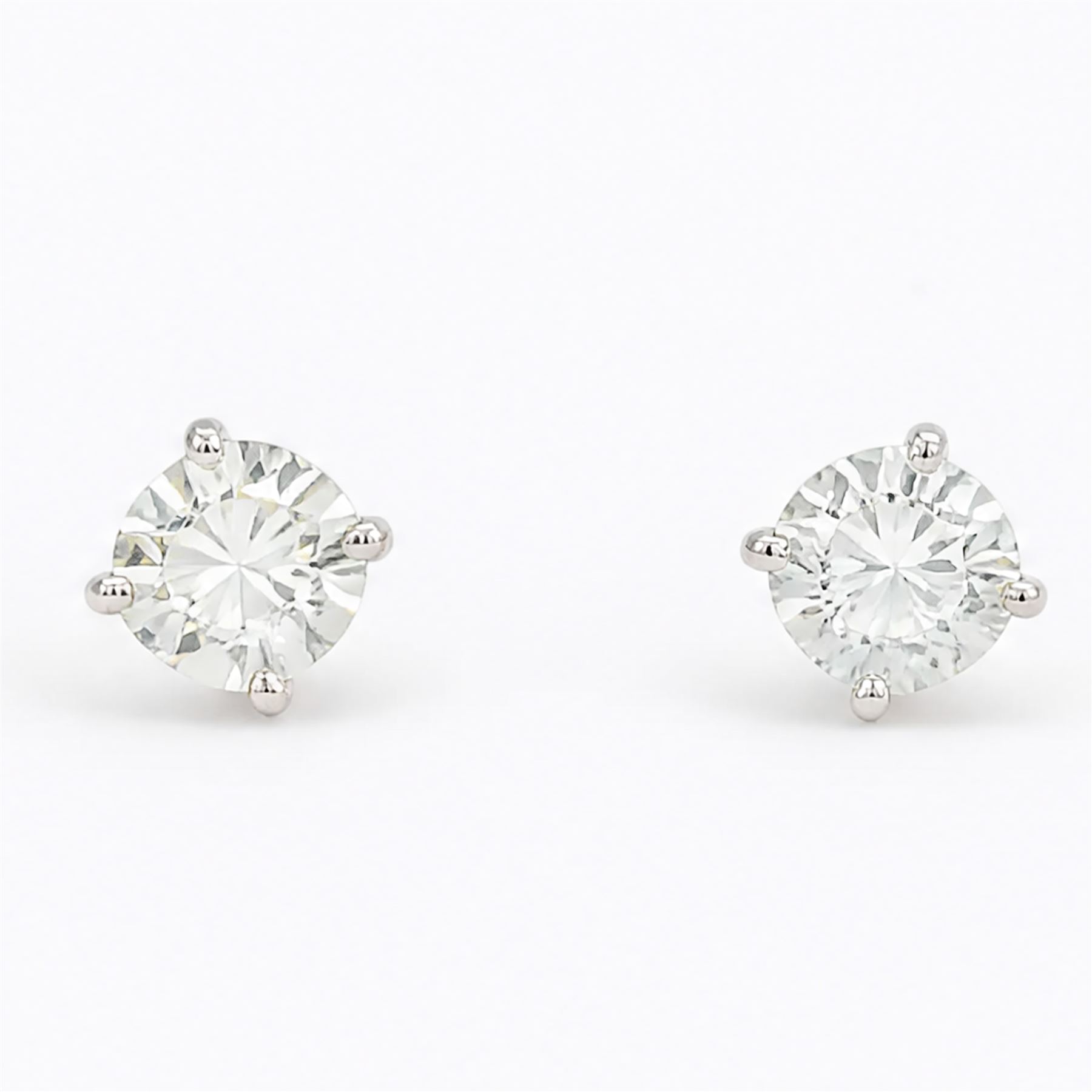 Pair of 18ct white gold diamond earrings, each stud set with a single round brilliant cut diamond, stamped 750, total diamond weight approx 1.00 carat