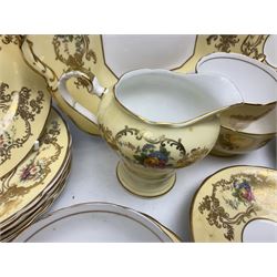 Aynsley tea service for six, decorated with floral sprays in ornate gilt detailing on cream ground, comprising six teacups and saucers, open sucrier and milk jug and cake plate, all with printed marks beneath