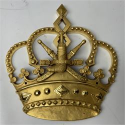 Gilt state emblem for Oman, a sheathed khanjar dagger superimposed above pair of crossed swords and belt and a seperate crown, main emblem H84cm, W83cm, crown H35cm, W33cm
Provenance by vendor repute: The emblem was previous mounted above HM's throne, in the main majalis, of the HM Royal Yacht AL Said, until 1985 when HM Sultan Qaboos ordered the upgrading of all state emblems, The emblem was gifted to the vendor who worked for the Sultans Royal Yacht Squadron