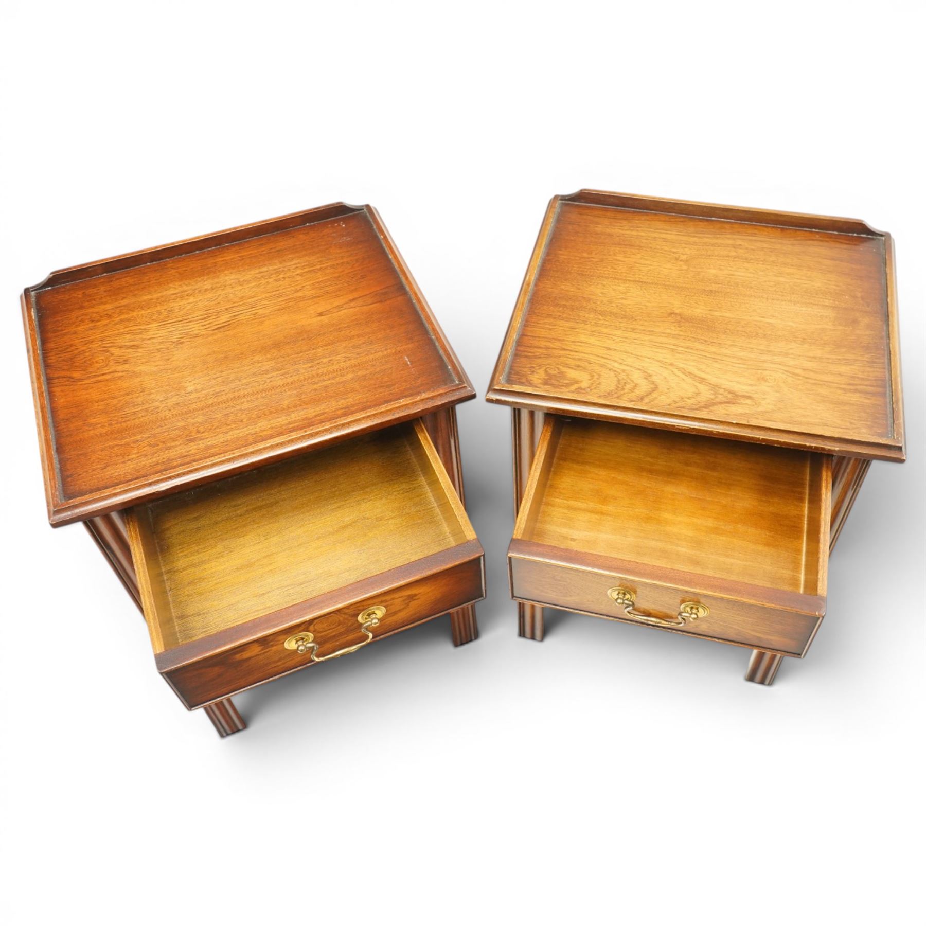 Pair of mahogany bedside tables, with quarter galleried top, single drawer with brass swan neck handle, pierced spandrels on fluted square supports  