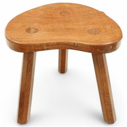 Mouseman - oak three-legged stool, dished kidney-shaped seat on three octagonal splayed supports, carved with mouse signature, by the workshop of Robert Thompson, Kilburn
