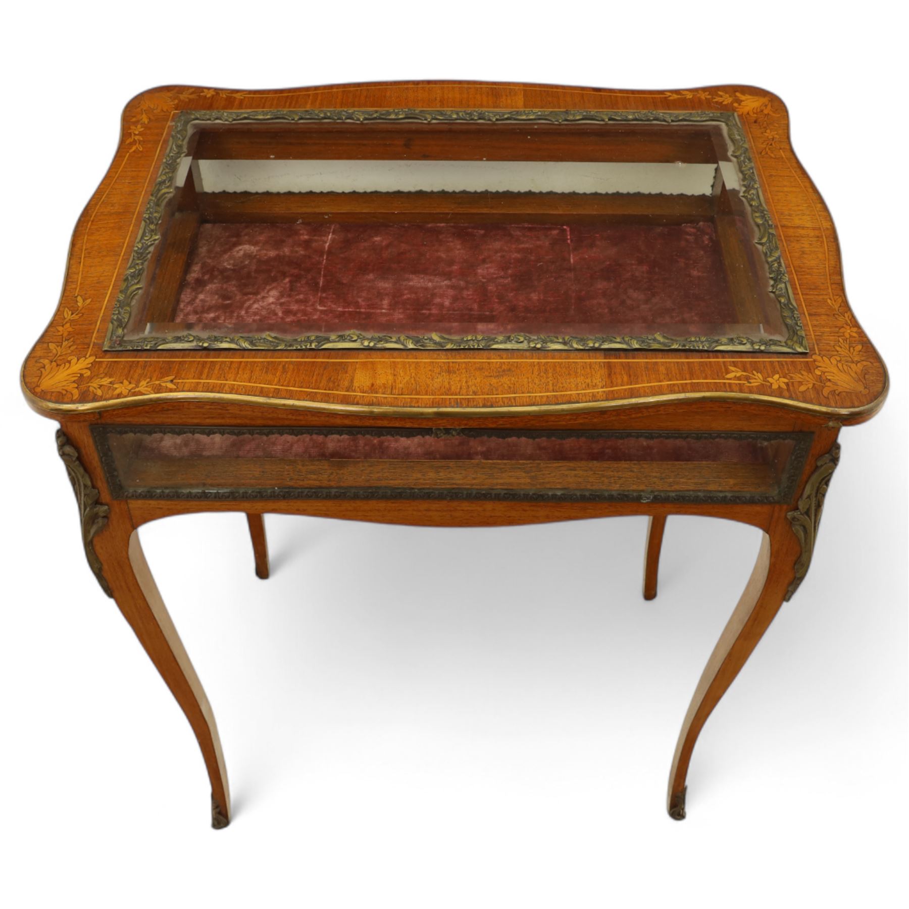 Louis XV revival style walnut bijouterie table, rectangular serpentine form, with brass edging and a hinged floral marquetry inlaid lid with bevelled glass top and sides, gilt-bronze beaded border, interior lined with rich red velvet, raised on slender cabriole legs with gilt bronze masks and sabots, circa 1900