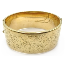  9ct gold hinged bangle, engraved leaf design approx 37.6gm  