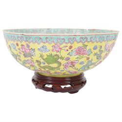 Chinese famille jaune eggshell porcelain bowl, decorated with dragons and foliage, upon hardwood stand, D26cm