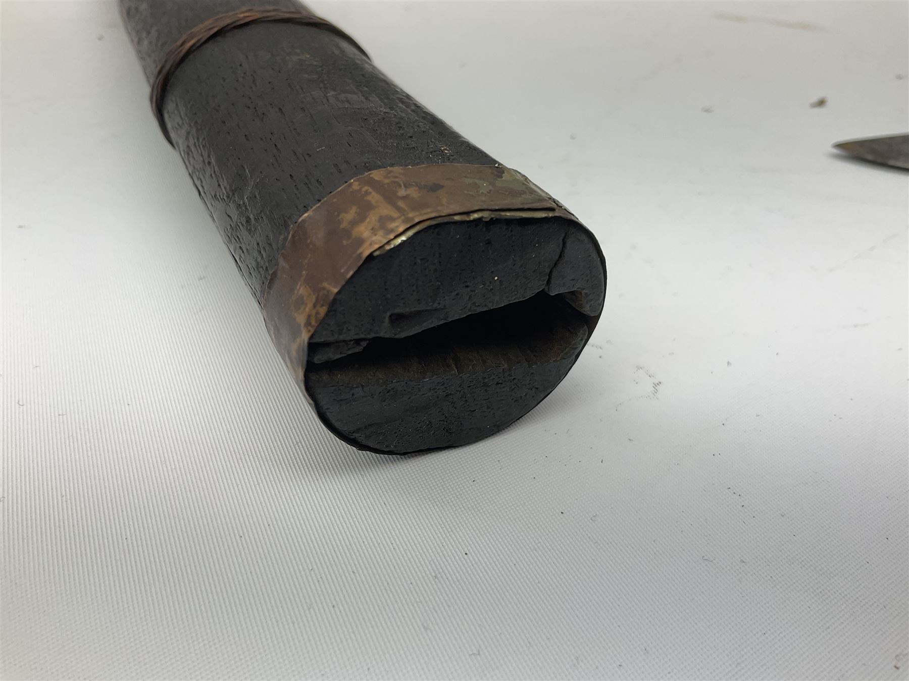 Burmese Dha type sword with 52cm plain steel slightly curving blade and plaited cane bound grip; in wooden scabbard with plaited cane bands L76.5cm overall