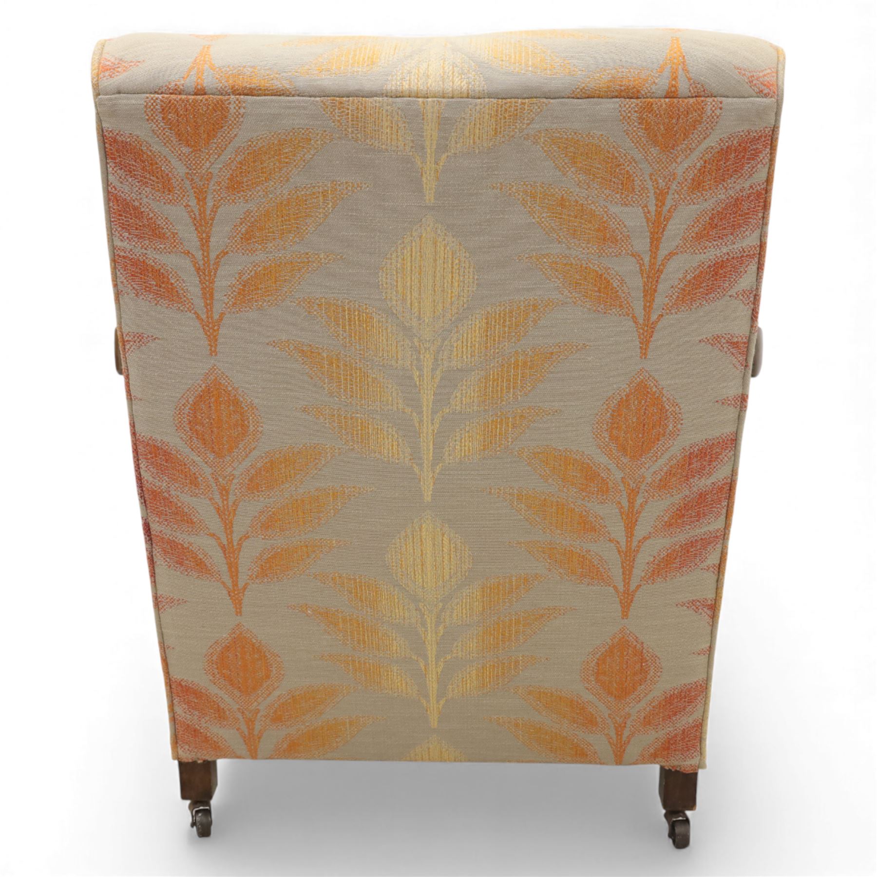 Pair of mid-20th century mahogany framed bergère armchairs, each with carved scroll arms and caned side panels, floral upholstered loose cushions, raised on cabriole front supports