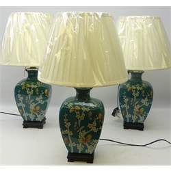  Three Oriental style table lamps decorated with butterflies amongst foliage on turquoise ground on brushed brass base with shades, as new, H33cm  