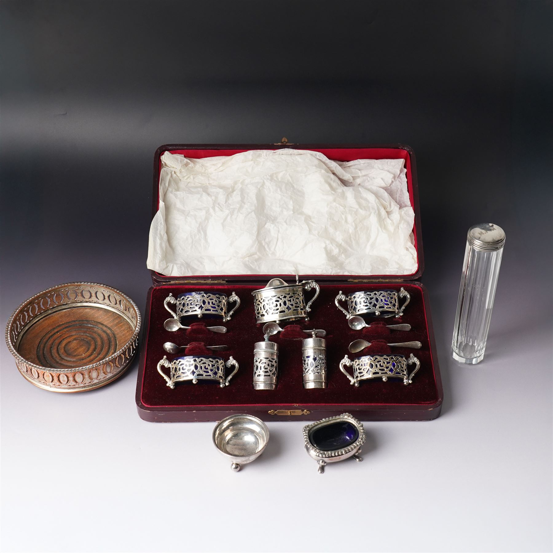 Set of four Edwardian pierced silver salts and matching mustard pot, all with blue glass liners Birmingham 1901 Maker William Devenport, cased, together with a pair of similar pepperettes 1900 Maker Walker & Hall, Georg Jensen sterling silver cauldron shape salt on ball feet, plated coaster, plated salt and silver topped jar