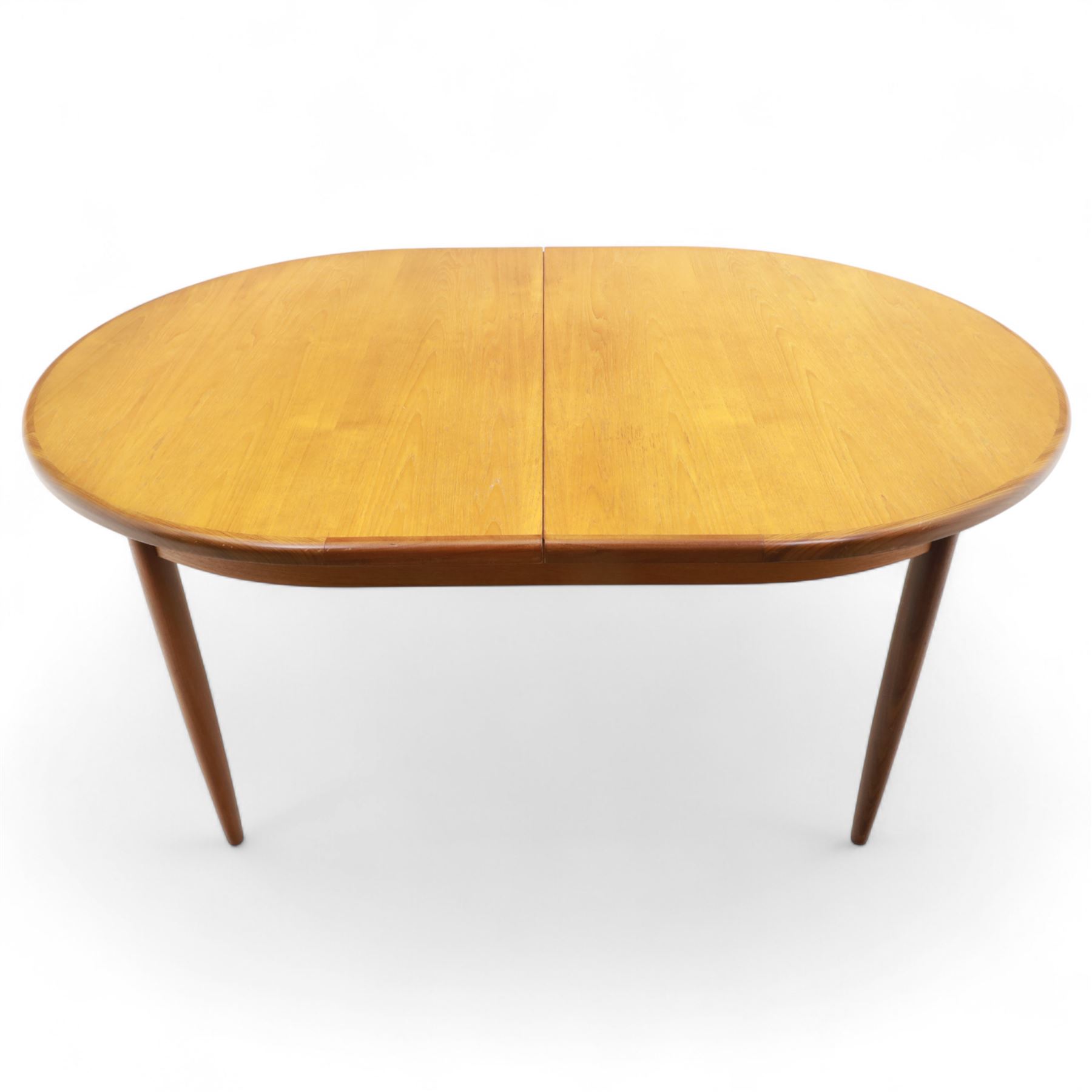 G Plan - mid-20th century teak extending dining table, oval top with integrated extension leaf, raised on tapering legs, together with a set of six slat back dining chairs including two carvers, upholstered in dark green velour (Extends to 210cm)