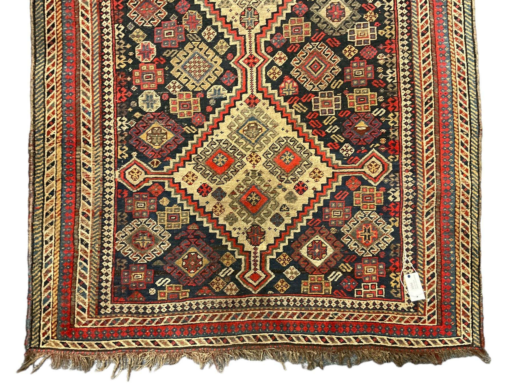 Old Persian Hamadan rug, the indigo ground field with three interlinked lozenge medallions, decorated all over with geometric and stylised motifs, eight band border with repeating geometric patterns 