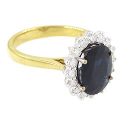 18ct gold sapphire and diamond cluster ring, single oval cut sapphire of approx 2.60 carat, surrounded by sixteen round brilliant cut diamonds, hallmarked, total diamond weight approx 0.45 carat