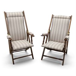 Pair of early 20th century oak framed garden reclining and folding deckchairs, high back a...