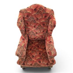 Large upholstered wingback chair, crimson geometric upholstery, carved front apron raised on cabriole supports 