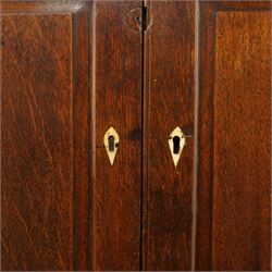 George III oak and mahogany bound enclosed bookcase-secretaire, panelled cupboards over four drawers