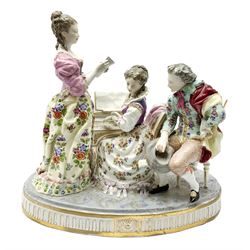 Large Continental figure group, in the Meissen style, modelled as three figures gathered around a piano, upon oval base with gilt detail to edge, with spurious blue crossed sword mark beneath, H30.5cm L32cm