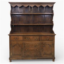 Georgian design oak dresser, the raised plate rack with shaped sides and two open shelves, upon a dresser base fitted with six drawers and two cupboard doors, and short block feet 