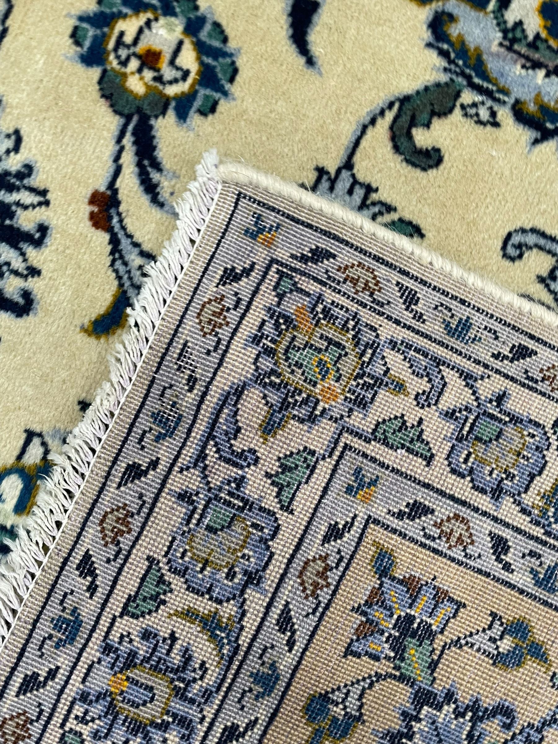Persian Nain pale sage ground carpet, decorated with curled leaf motifs and palmettes, the busy borders decorated densely with similar design, within floral pattern guard stripes 