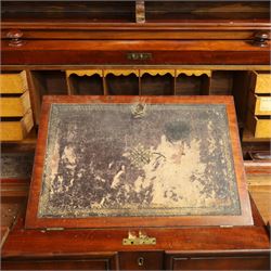 Victorian mahogany cylinder roll-top bookcase-secretaire, projecting cornice over twin glazed doors enclosing two shelves, the cylinder roll-top enclosing fitted interior with sliding drawer, hinged compartments, correspondence drawers and pigeon-holes, the twin pedestals fitted with three graduating drawers to each side, on plinth bases with castors