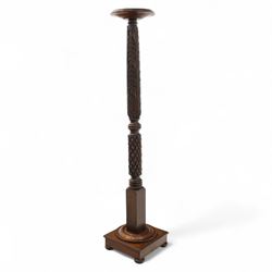 Late 20th century carved mahogany torchère stand, dished top above heavily carved column, with turned elements on moulded square base upon bun feet