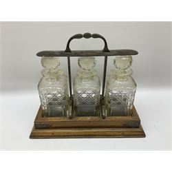  Edwardian oak tantalus with silver plated locking mechanism and three square sided glass decanters, complete with key, H32cm