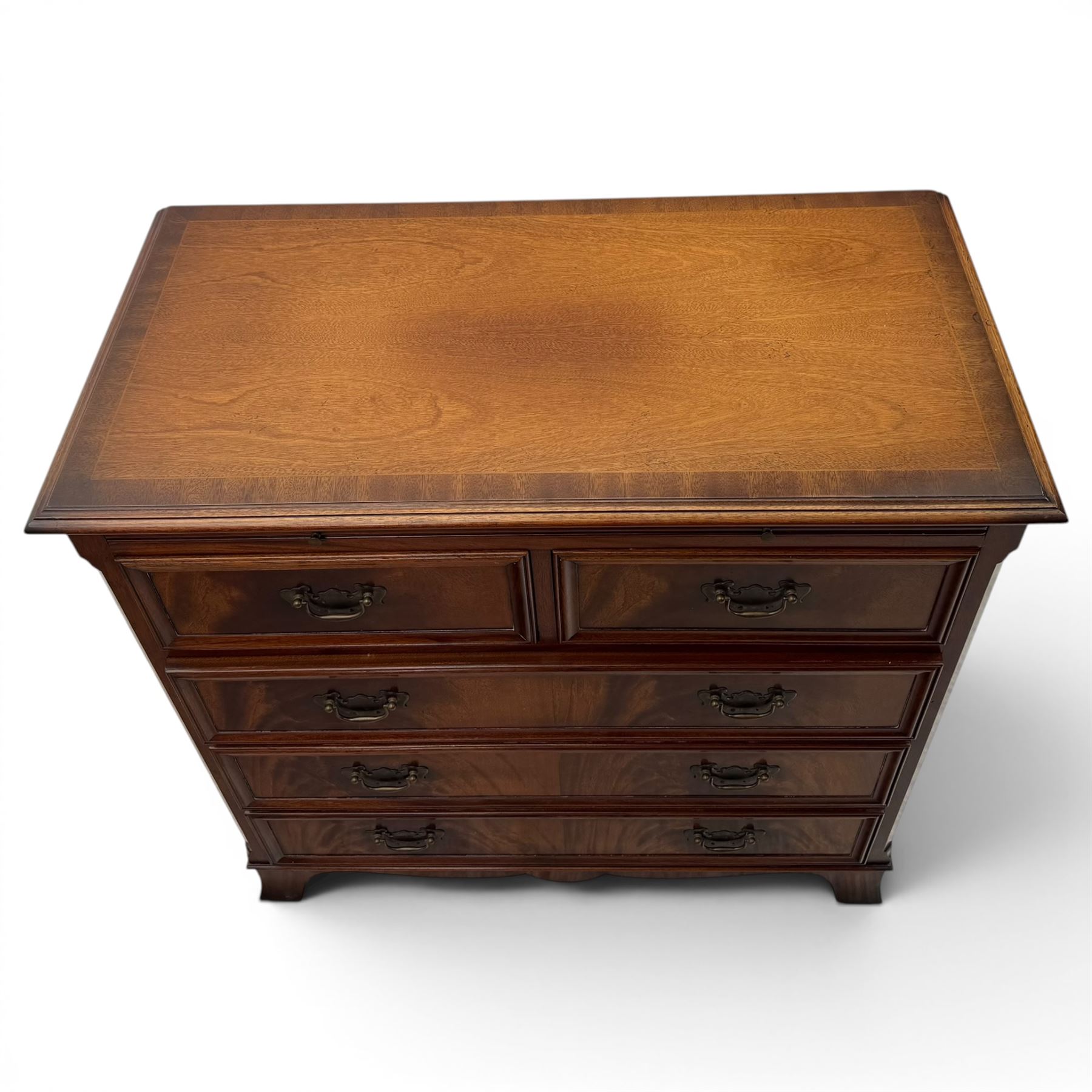 Charles Barr - mahogany bachelor's chest, with brushing slide two short over three long drawers with moulded edges, shaped apron raised on bracket feet