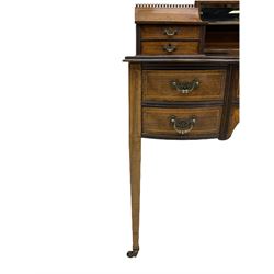 Late Victorian rosewood Carlton House type writing desk, raised bevelled mirror back flanked by two curved compartments with drawers, inlaid with urns, linen swags and scrolling foliate, the moulded top fitted with tooled leather inset over five drawers, square tapering supports with brass cups and castors