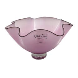 Gillies Jones pink glass bowl with crimped black rim upon a pedestal foot, H11cm