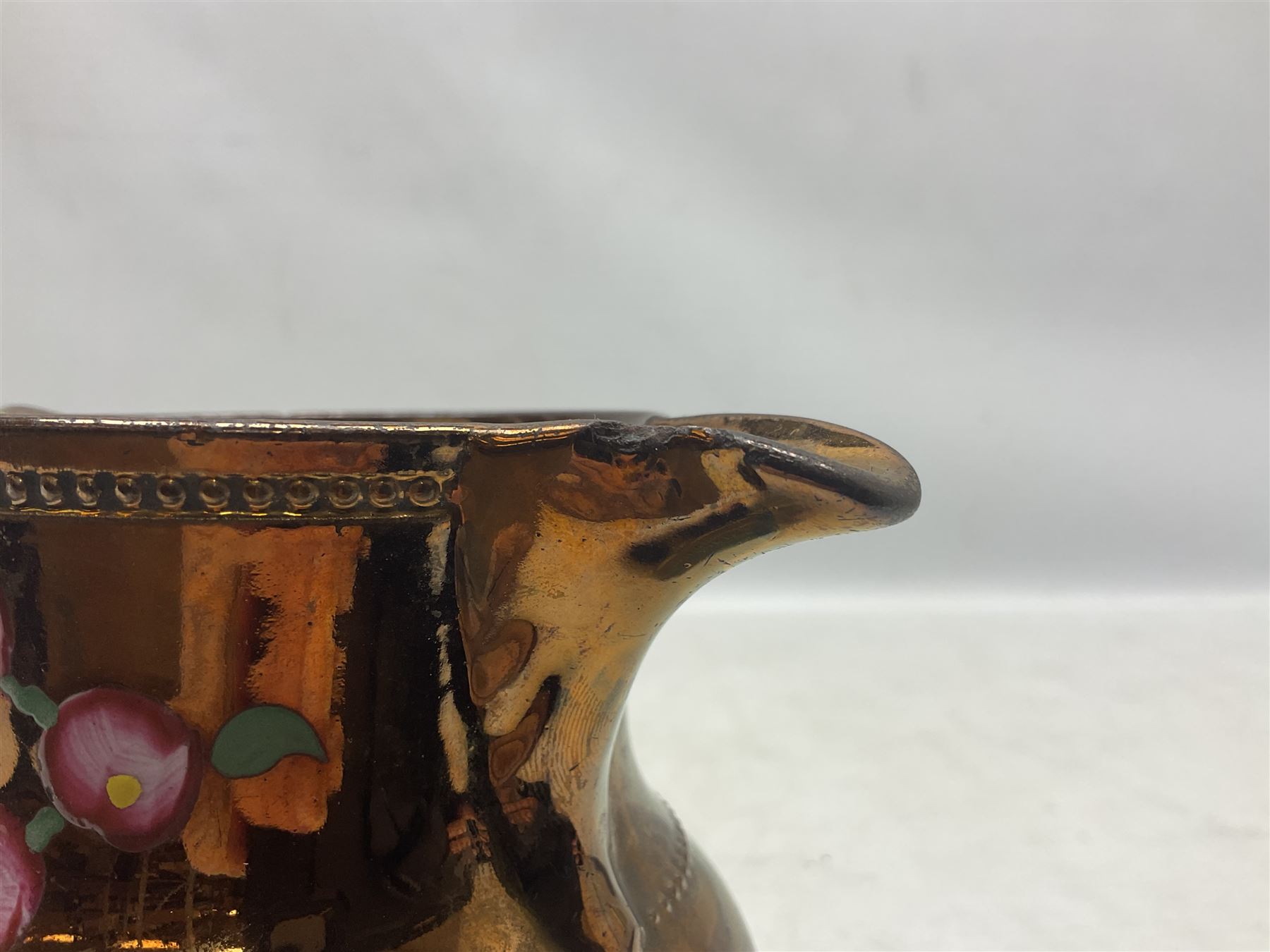 Early 20th century Sunderland lustre jug, decorated with transfer Masonic scene and poem 'The World is in Pain/Our Secrets to Gain/But Still Let Them Wonder and Gaze/The Never Can Divine/The World Nor The Sign/Of a Free and Accepted Mason', the reverse decorated with Sunderland River Wear cast iron bridge scene below text (a/f), together with a copper lustre jug, and pink lustre bowl, jug H20cm