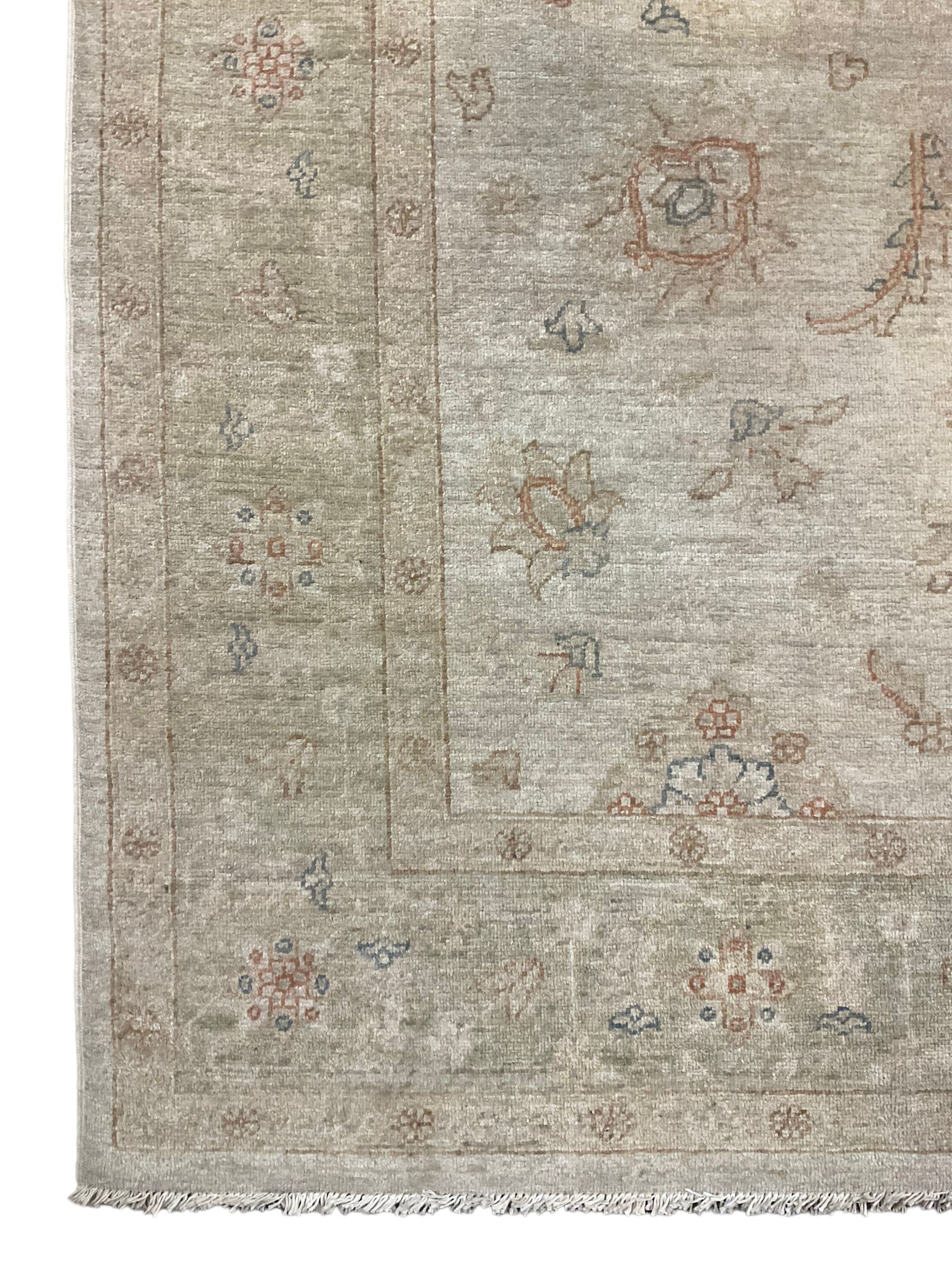 Persian Zeigler rug, ivory ground and decorated with stylised plant motifs, floral design border