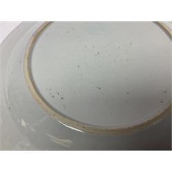 Three 18th century Chinese Famille Rose plates, the first example enamelled with blossoming peonies, rockwork and fence, the other two examples of similar design, decorated with blossoming peonies and sprigs within shaped inner borders, each approximately D23cm