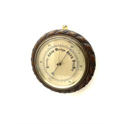 Mid 20th century circular oak cased barometer, silvered dial with register, rope carved edge moulding
