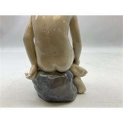 Royal Copenhagen 'Girl on Stone' figure modelled as a female nude seated upon a rock, designed by Ada Bonfils, model no. 4027, with printed and painted marks beneath, H14cm