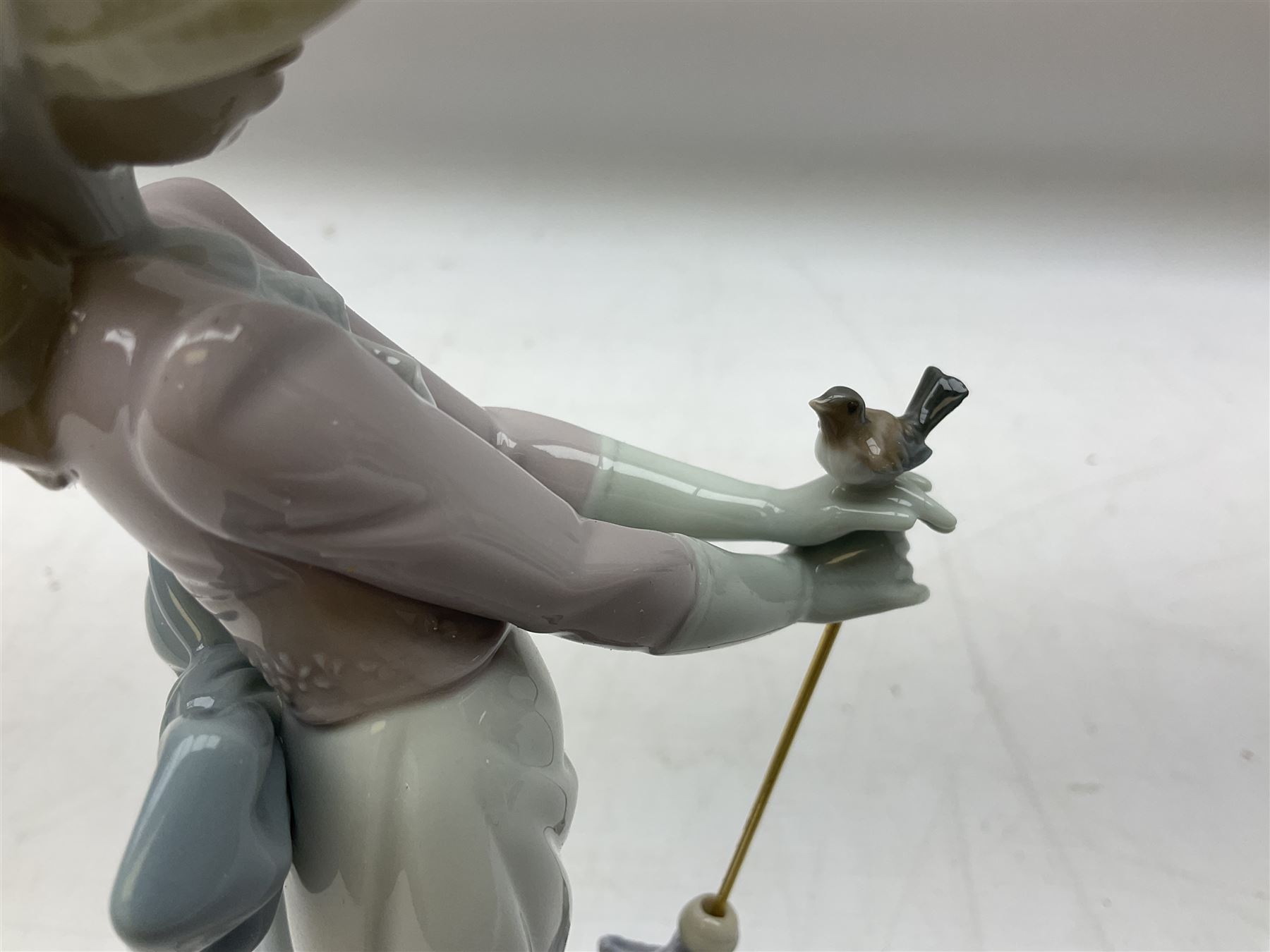 Two Lladro figures, comprising Garden Classic, no 7617 and Garden Song, no 7618, with original boxes and artists signature beneath, largest example H23cm