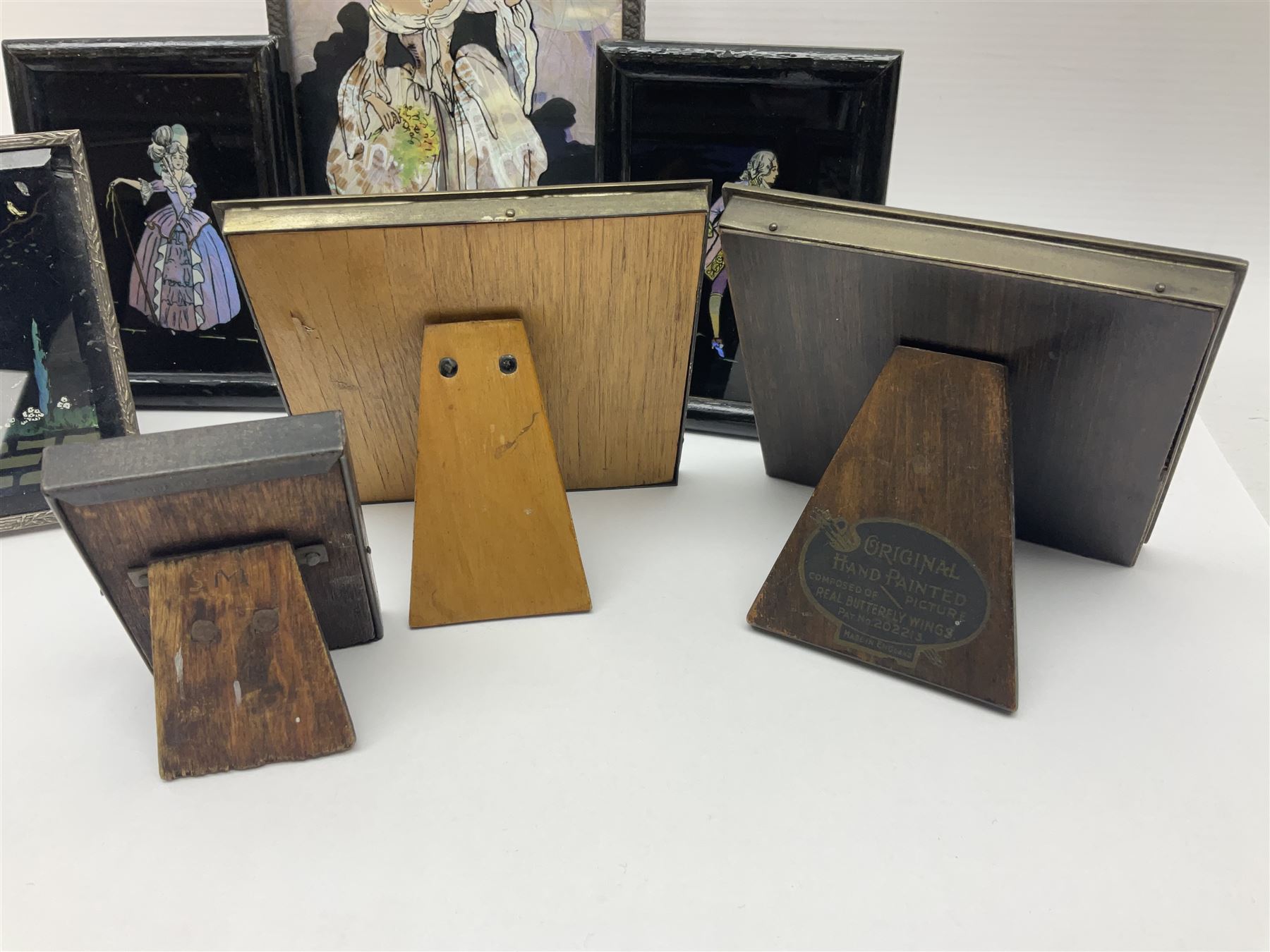 Seven 1930's butterfly wing pictures, mainly of ladies in period dress, one signed Dorothy Buckley, largest H18cm