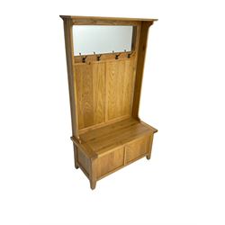 Oak mirror-back hall bench, projecting cornice, rectangular bevelled plate over four coat hooks, hinged box seat compartment with panelled front, on square tapering feet