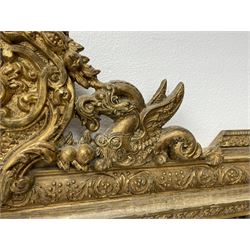 20th century gilt frame rectangular mirror, ornate central cartouche pediment set with two winged dragons, the frame decorated with scrolling leafage and berries